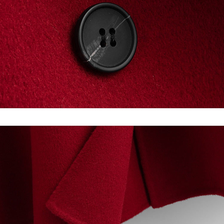 A long double breasted coat with wide lapels and front patch pockets displayed on a hanger._7