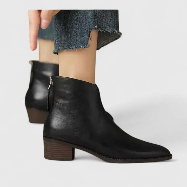 Black ankle boots with block heel and side zipper worn with frayed hem denim shorts_0