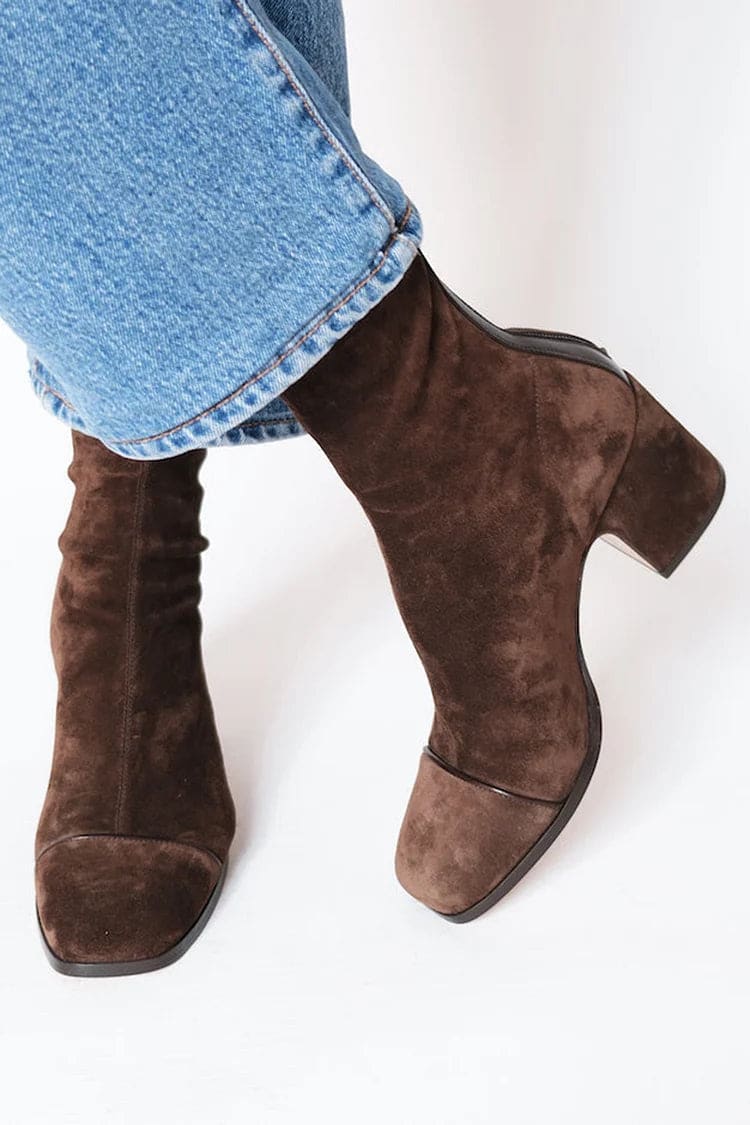Woman wearing brown ankle boots with block heel and square toe, styled with light blue jeans._0
