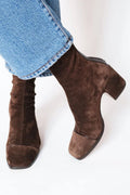 Woman wearing brown ankle boots with block heel and square toe, styled with light blue jeans._0