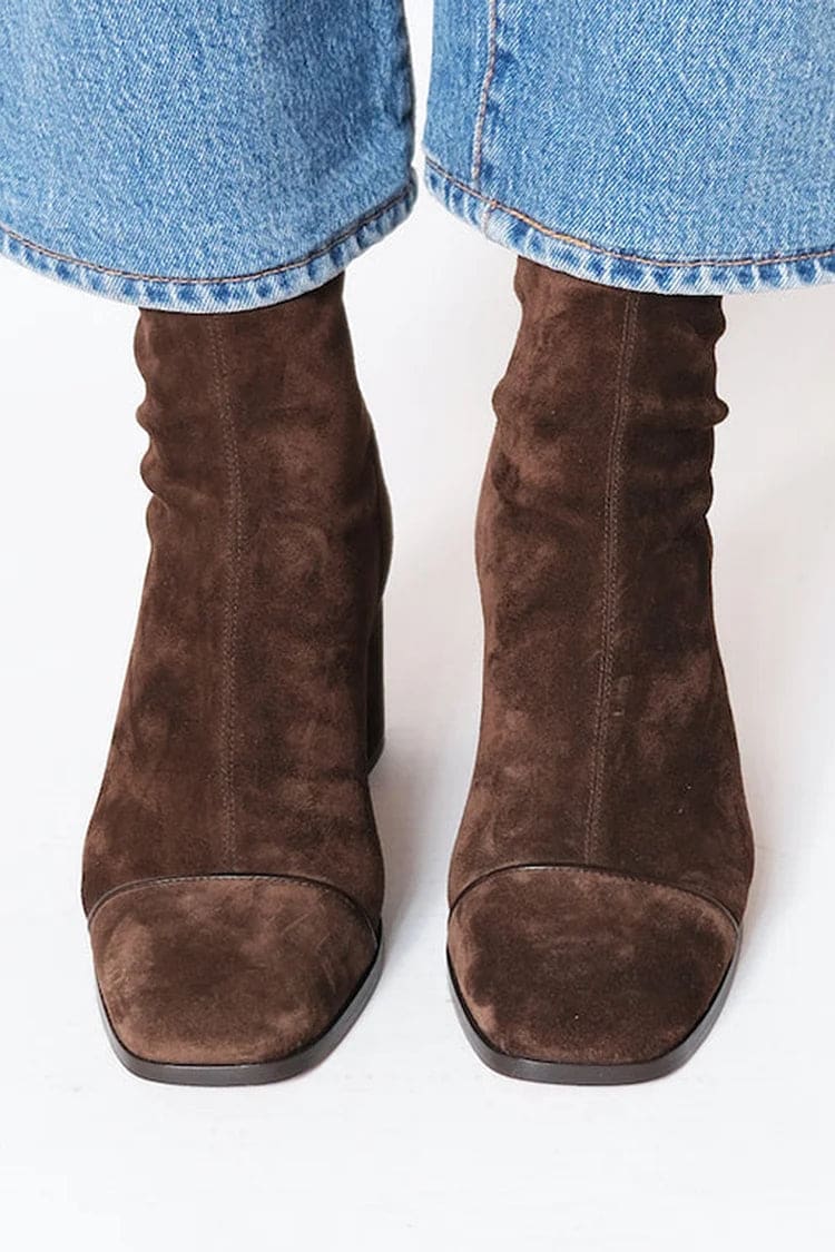 Woman wearing brown ankle boots with block heel and square toe, styled with light blue jeans._1