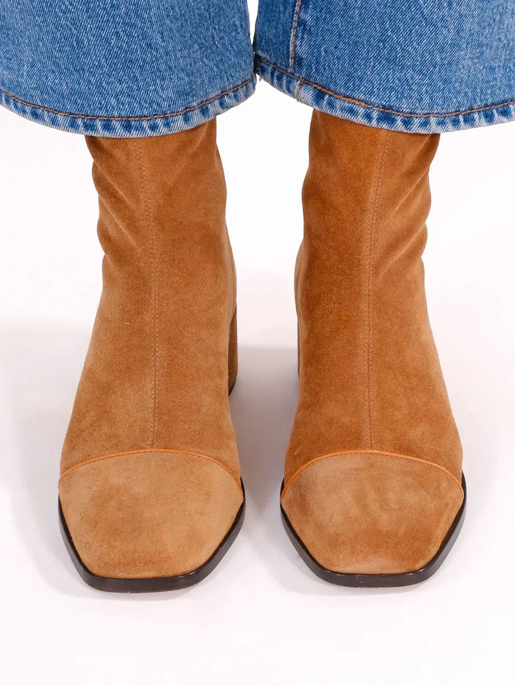 Woman wearing brown ankle boots with block heel and square toe, styled with light blue jeans._2