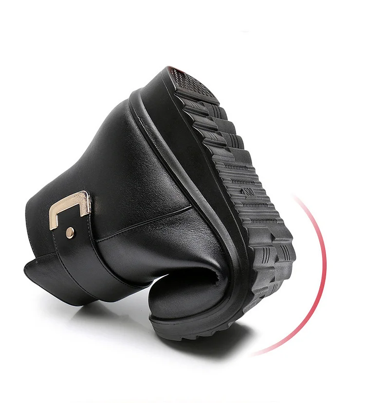 Close-up of a black ankle boot with a buckle strap detail and cushioned sole._5