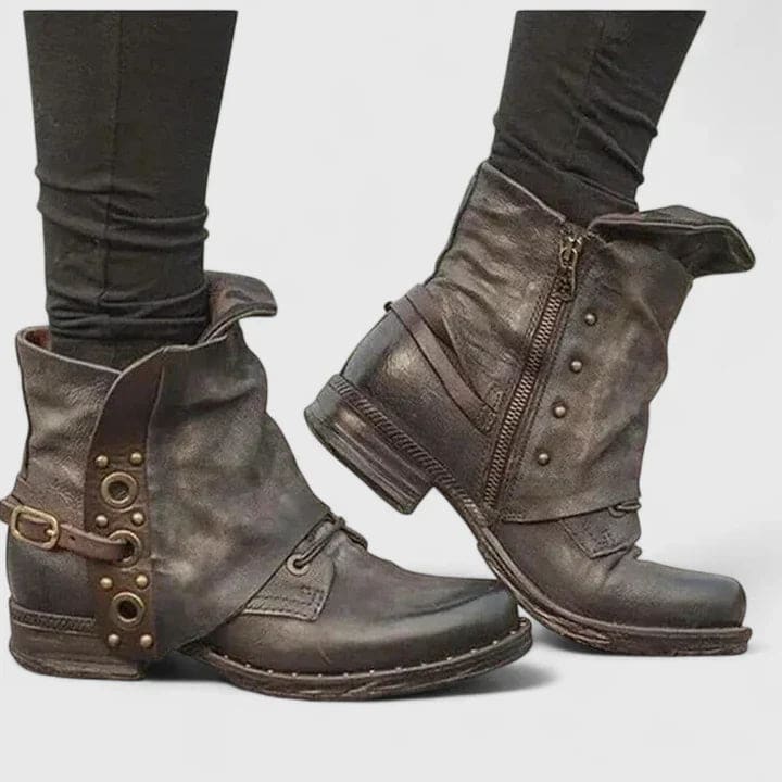 Distressed ankle boots with buckle straps and side zipper worn with dark skinny jeans._0