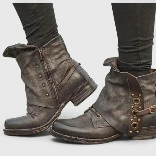Distressed ankle boots with buckle straps and side zipper worn with dark skinny jeans._1