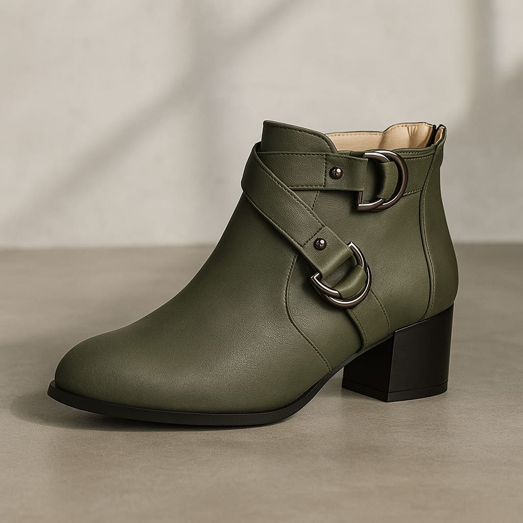 Tan ankle boot with double buckle straps across the front and a chunky block heel, shown from the side against a neutral background._11