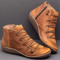 Pair of ankle boots with criss-cross lacing detail and side zipper closure displayed on a neutral background_0
