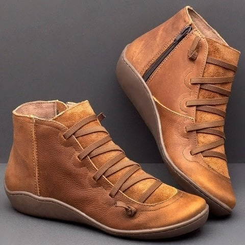 Pair of ankle boots with criss-cross lacing detail and side zipper closure displayed on a neutral background_0