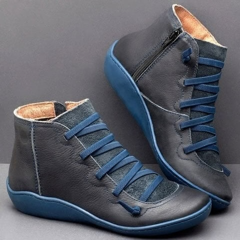 Pair of ankle boots with criss-cross lacing detail and side zipper closure displayed on a neutral background_12