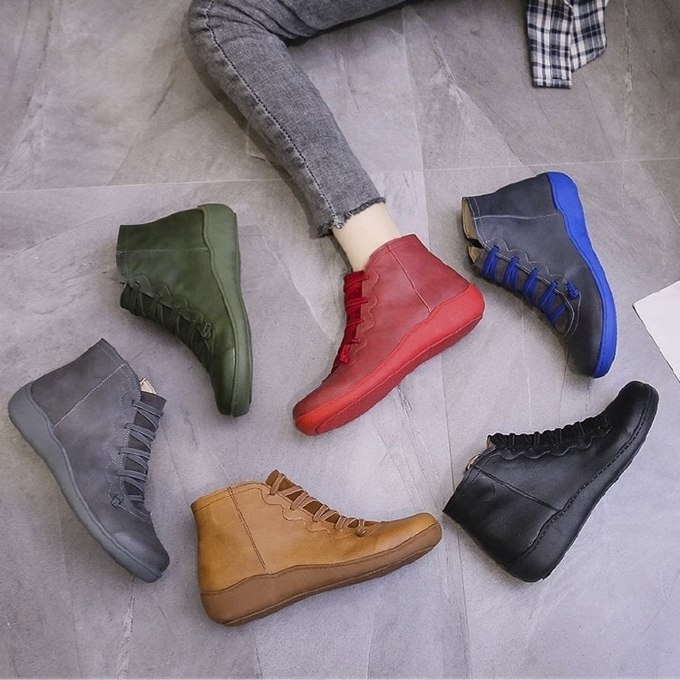 Pair of ankle boots with criss-cross lacing detail and side zipper closure displayed on a neutral background_13