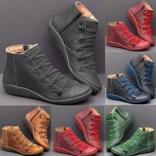 Pair of ankle boots with criss-cross lacing detail and side zipper closure displayed on a neutral background_14