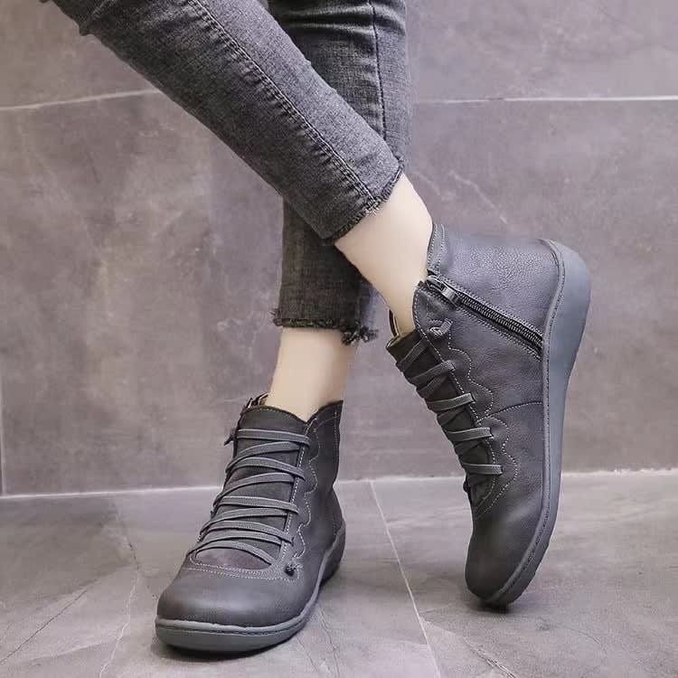 Pair of ankle boots with criss-cross lacing detail and side zipper closure displayed on a neutral background_4