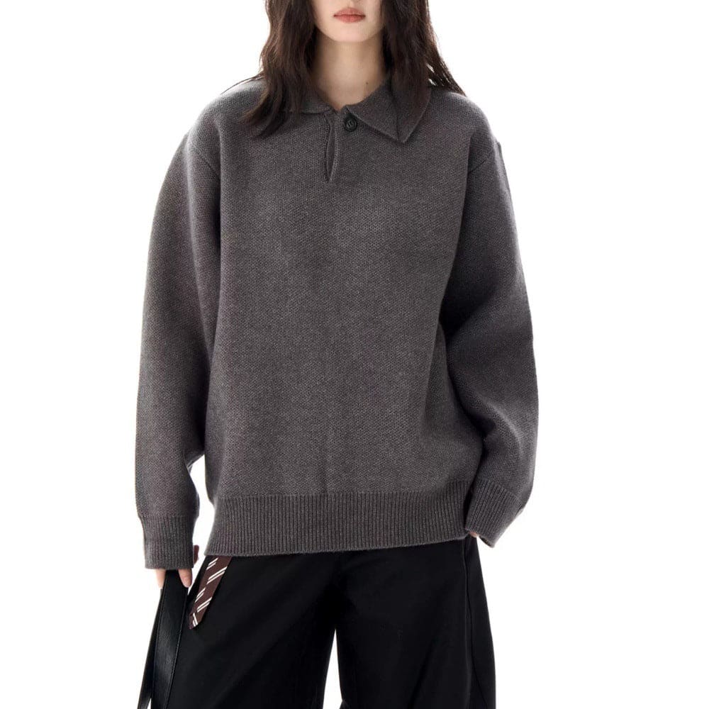 A model wears a relaxed long sleeve pullover sweater with a collared half zip neckline and ribbed trim._0