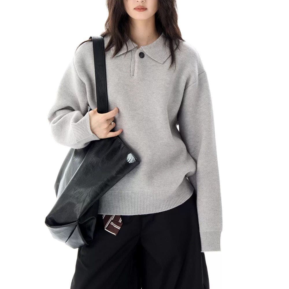 A model wears a relaxed long sleeve pullover sweater with a collared half zip neckline and ribbed trim._4