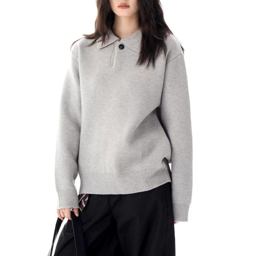 A model wears a relaxed long sleeve pullover sweater with a collared half zip neckline and ribbed trim._5