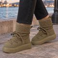 Khaki lace-up ankle boots with textured teddy shafts, metal eyelets and thick treaded platform soles, worn with dark grey jeans on a stone waterfront._0