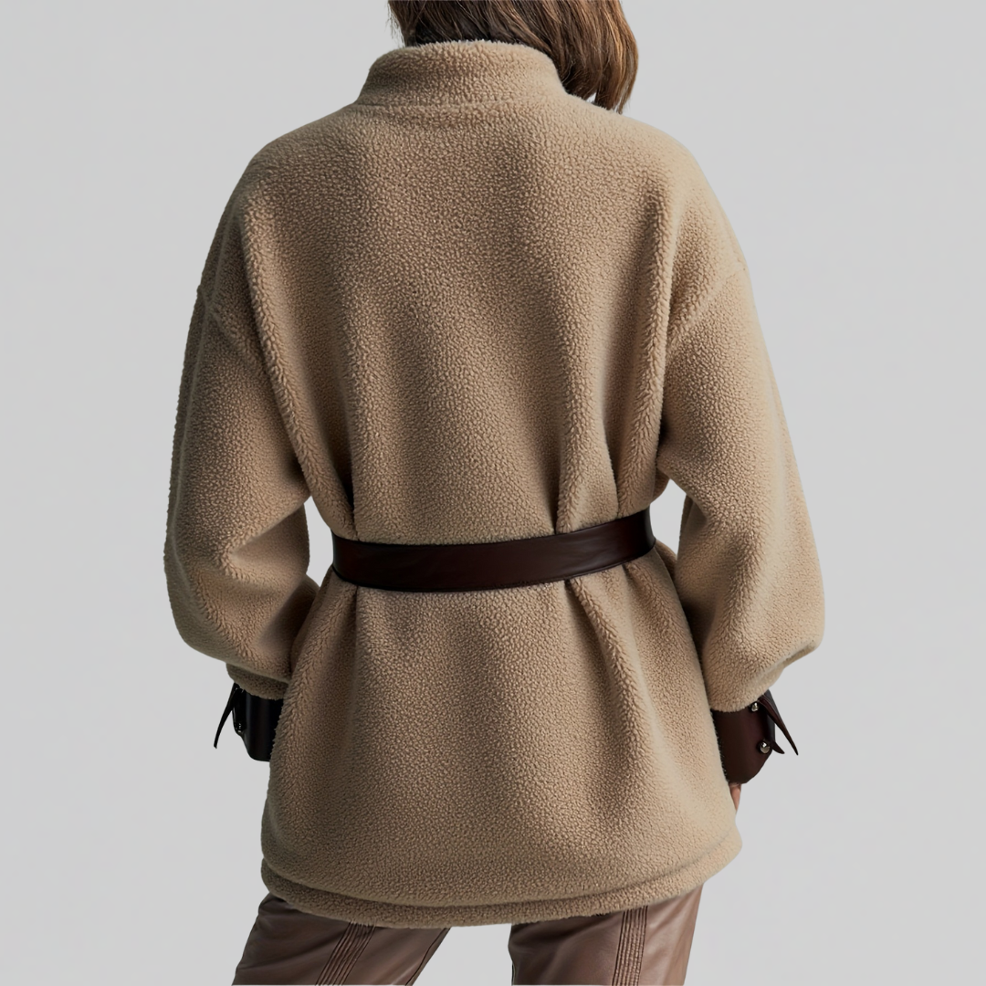 Woman wearing a textured teddy jacket with contrast trim, belted waist, and chest pockets._1