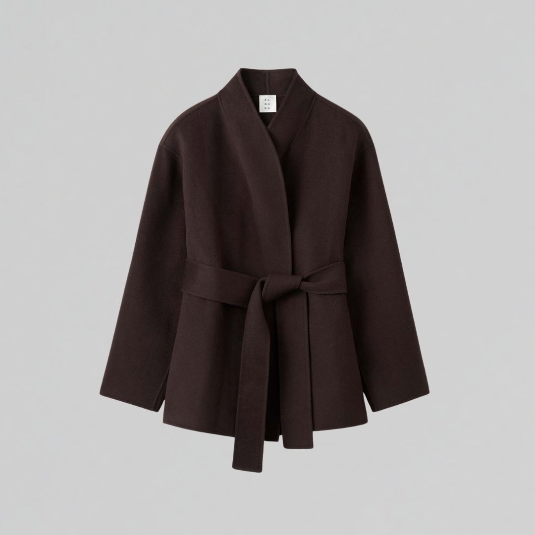 Woman wearing a dark belted wrap jacket with shawl collar and tie waist, styled with matching pants._2
