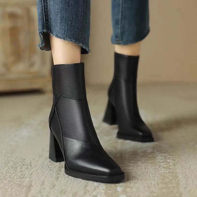 Side view of a block heel ankle boot with clean seam detailing and side zip closure worn on a foot against a neutral background._2