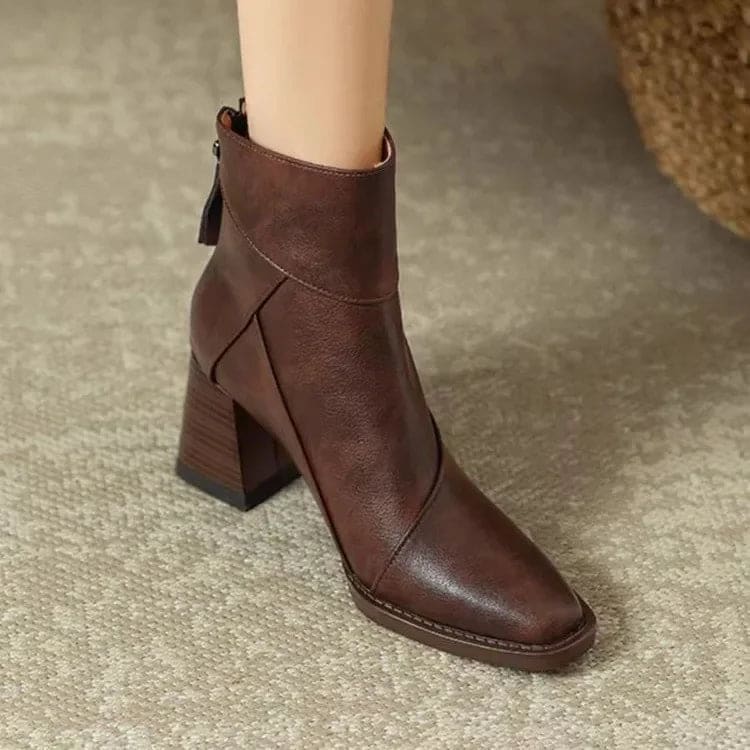 Side view of a block heel ankle boot with clean seam detailing and side zip closure worn on a foot against a neutral background._3