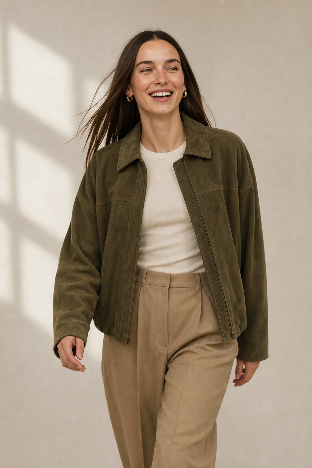 Model wearing a relaxed bomber jacket with lapel collar and zip closure, styled with white pants_4