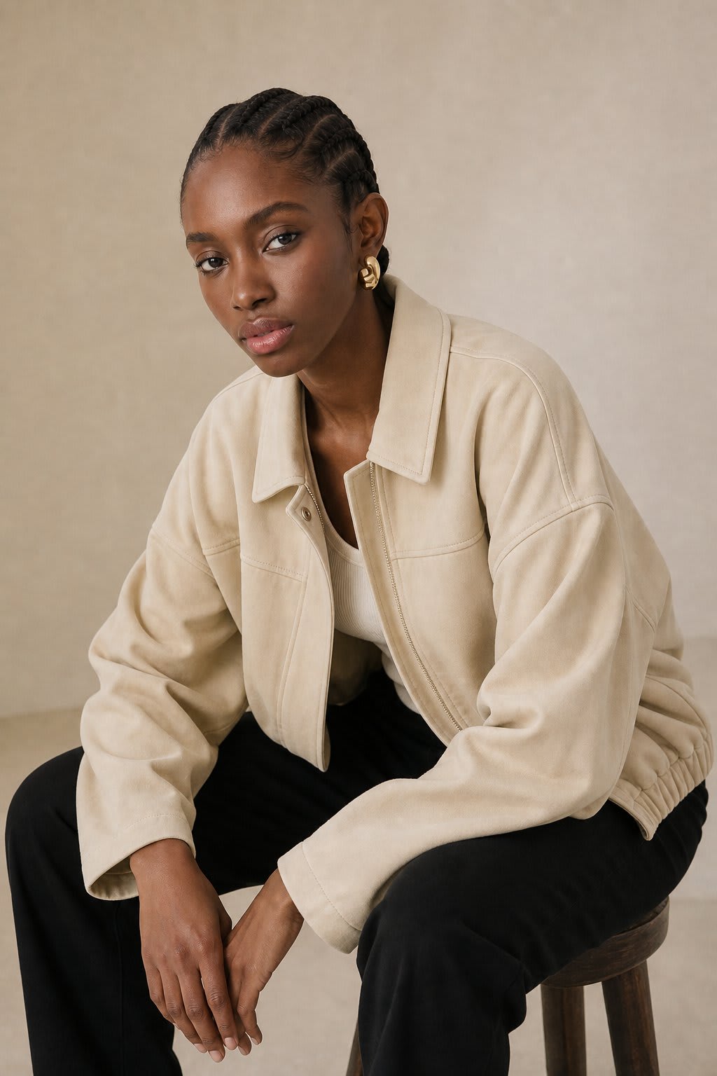 Model wearing a relaxed bomber jacket with lapel collar and zip closure, styled with white pants_6