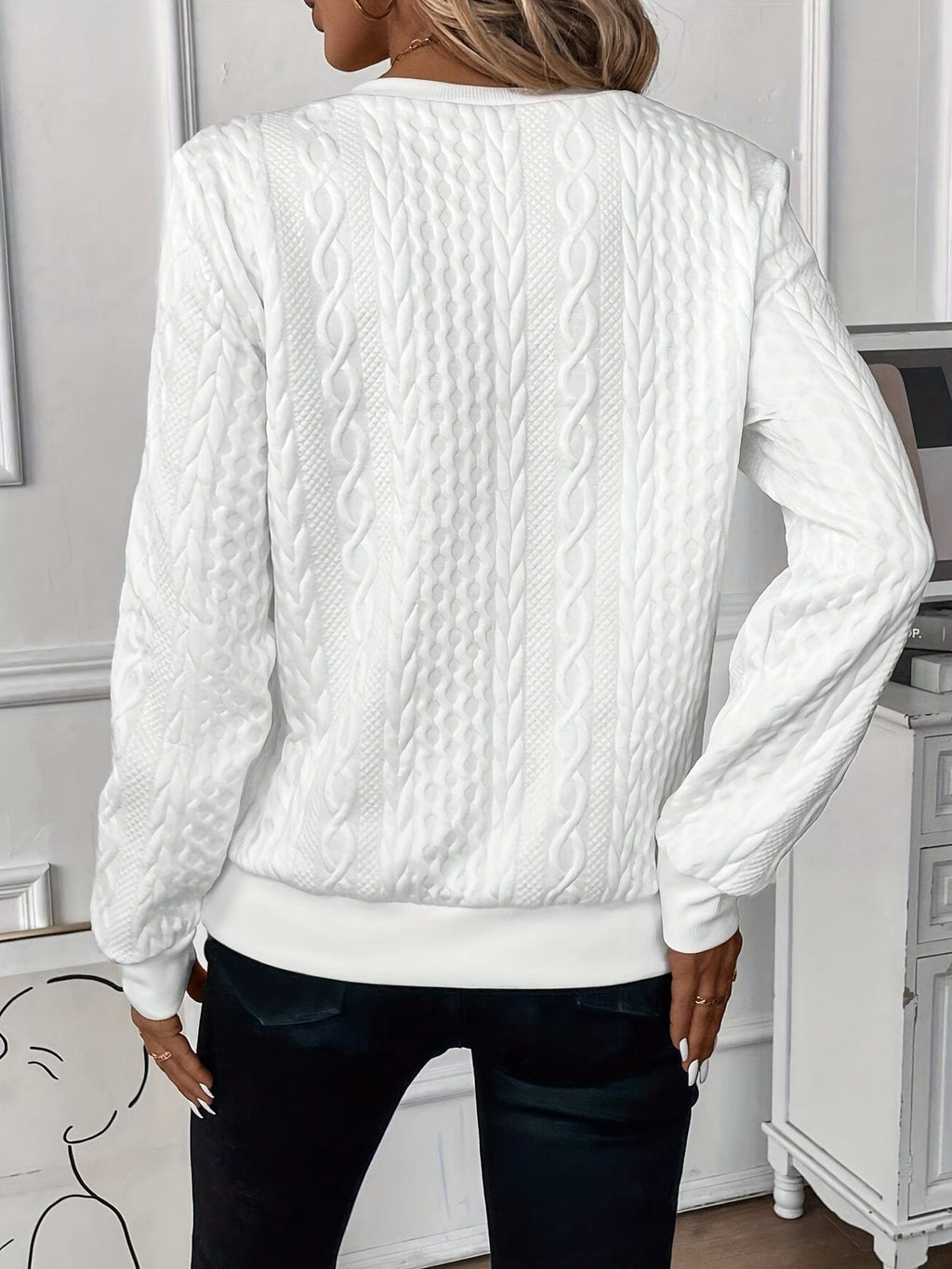Woman wearing a textured cable knit zip-up sweater with ribbed cuffs and hem, styled with dark pants._1