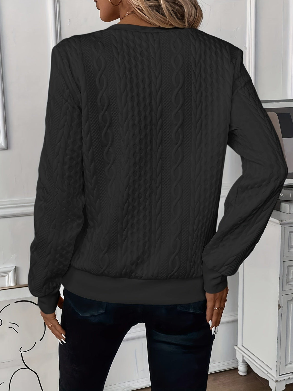 Woman wearing a textured cable knit zip-up sweater with ribbed cuffs and hem, styled with dark pants._5