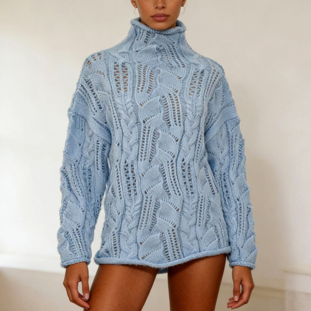 Woman wearing an oversized light blue cable and open knit turtleneck sweater with long sleeves and rolled hem._0