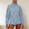 Woman wearing an oversized light blue cable and open knit turtleneck sweater with long sleeves and rolled hem._0