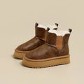 Pair of tan chelsea boots with elastic side panels, chunky platform soles, and soft faux fur lining displayed against a neutral background._0