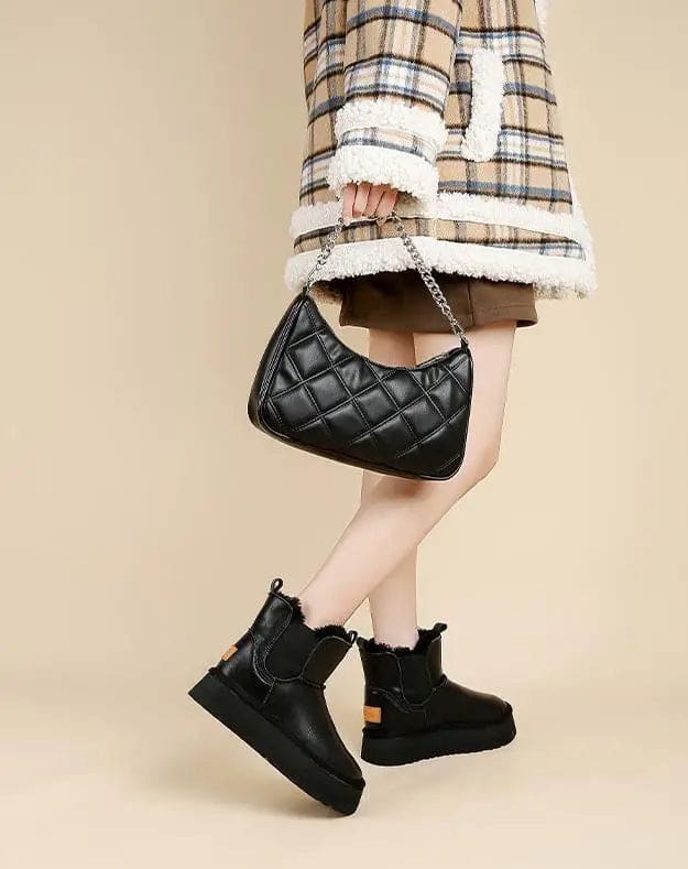 Pair of tan chelsea boots with elastic side panels, chunky platform soles, and soft faux fur lining displayed against a neutral background._27