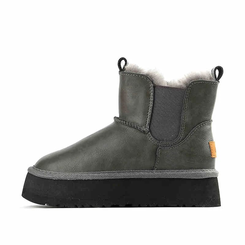Pair of tan chelsea boots with elastic side panels, chunky platform soles, and soft faux fur lining displayed against a neutral background._28