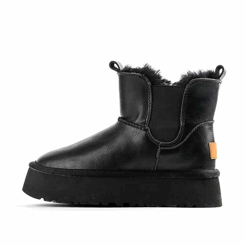 Pair of tan chelsea boots with elastic side panels, chunky platform soles, and soft faux fur lining displayed against a neutral background._29