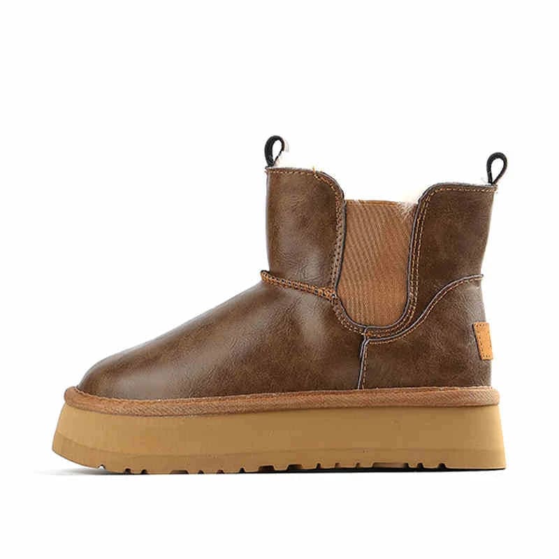 Pair of tan chelsea boots with elastic side panels, chunky platform soles, and soft faux fur lining displayed against a neutral background._30