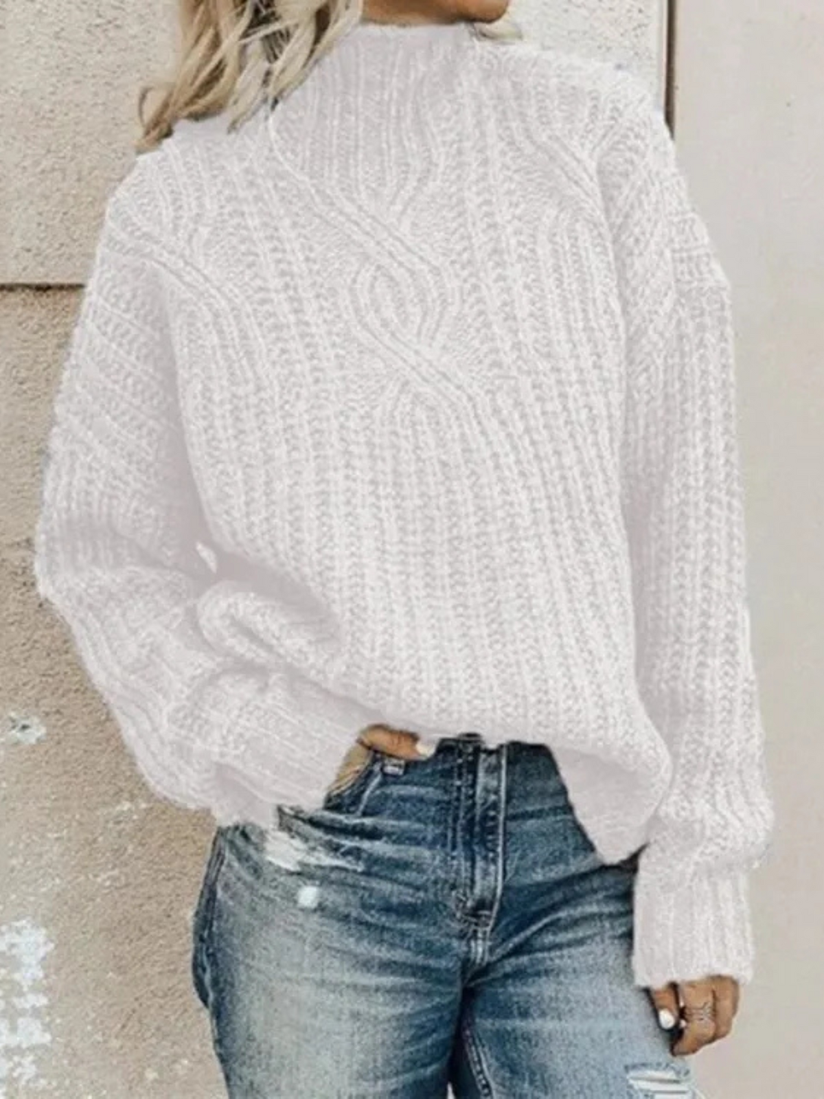 White chunky knit mock neck sweater with a subtle raised texture, long sleeves, and an easy fit styled with distressed denim.