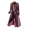 A long burgundy wrap coat with an asymmetric buttoned neckline, waist tie belt, and side welt pockets displayed on a hanger._0