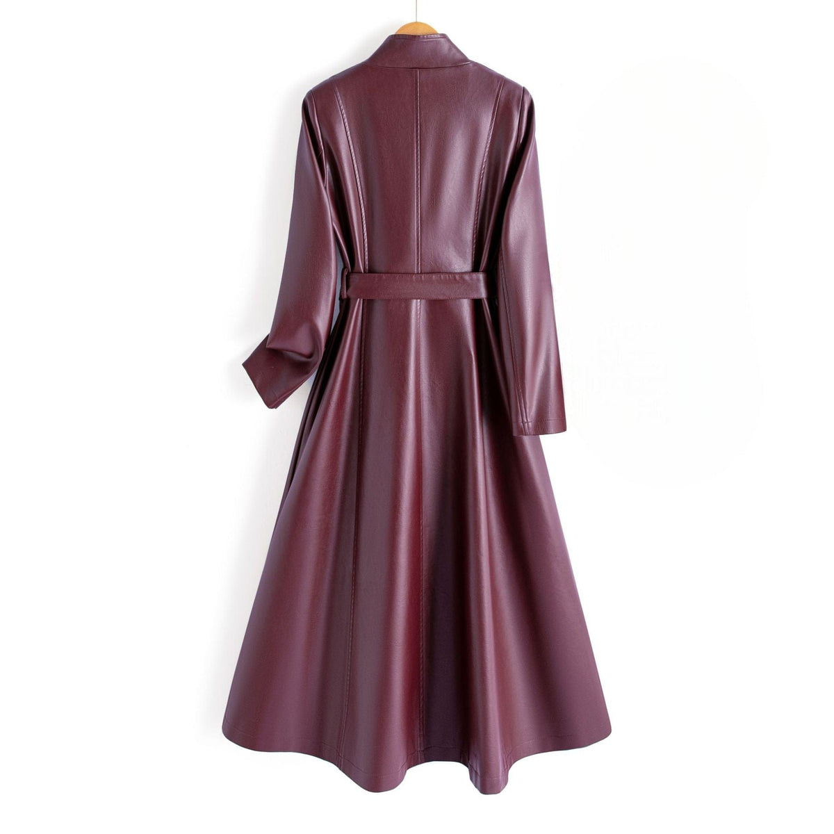 A long burgundy wrap coat with an asymmetric buttoned neckline, waist tie belt, and side welt pockets displayed on a hanger._1