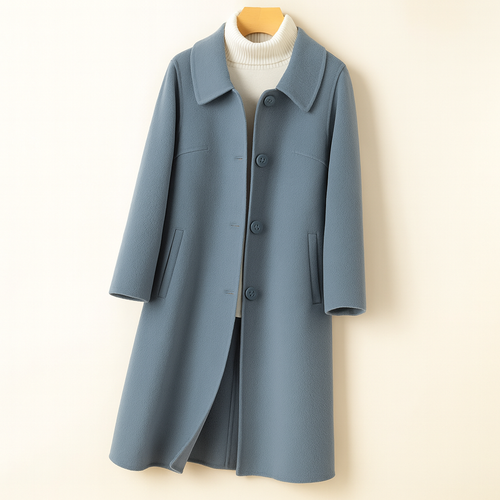 A mid length button front coat with a pointed collar, long sleeves, and side welt pockets shown on a hanger._0