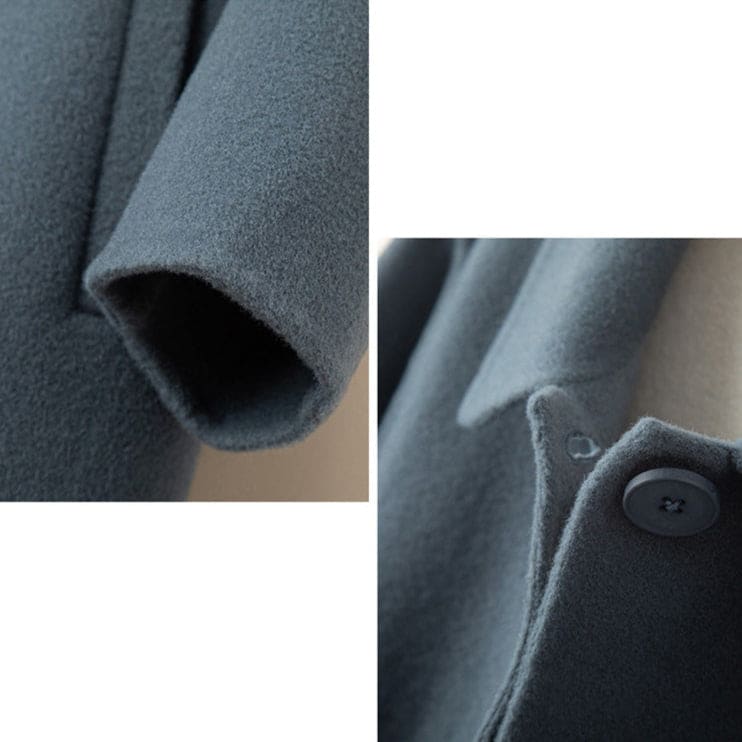 A mid length button front coat with a pointed collar, long sleeves, and side welt pockets shown on a hanger._8