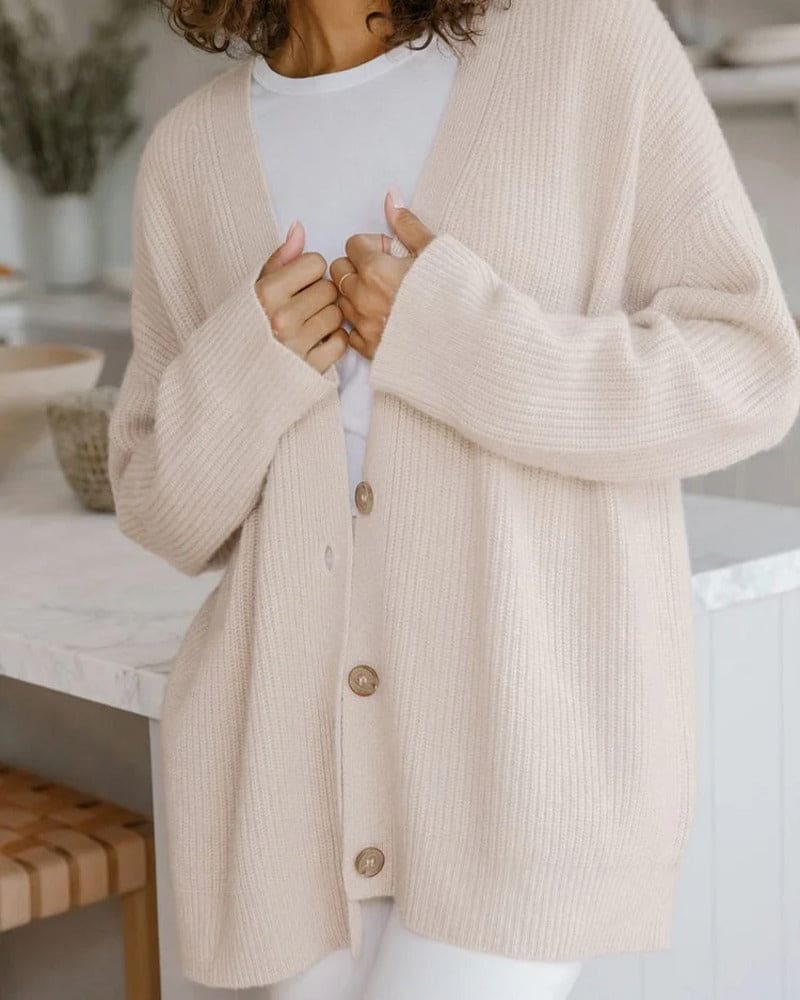 Woman wearing an oversized ribbed cardigan with button-front closure and relaxed cocoon fit, styled with neutral pants._7