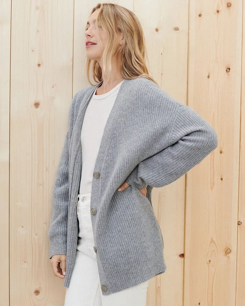 Woman wearing an oversized ribbed cardigan with button-front closure and relaxed cocoon fit, styled with neutral pants._9