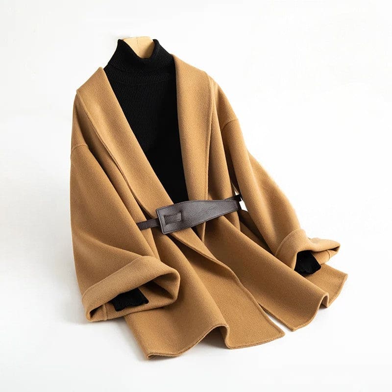 A wrap coat with wide sleeves, a kimono inspired silhouette, and an adjustable belt displayed over a black turtleneck._0