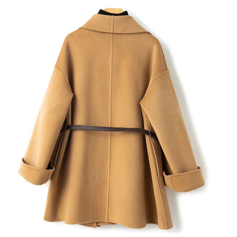 A wrap coat with wide sleeves, a kimono inspired silhouette, and an adjustable belt displayed over a black turtleneck._2