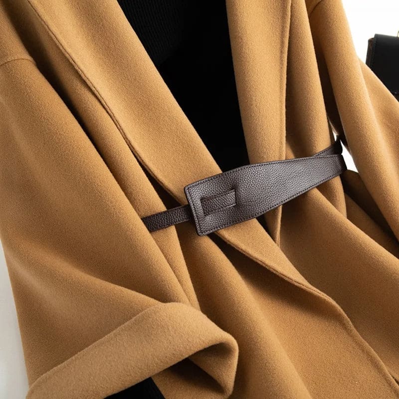 A wrap coat with wide sleeves, a kimono inspired silhouette, and an adjustable belt displayed over a black turtleneck._5