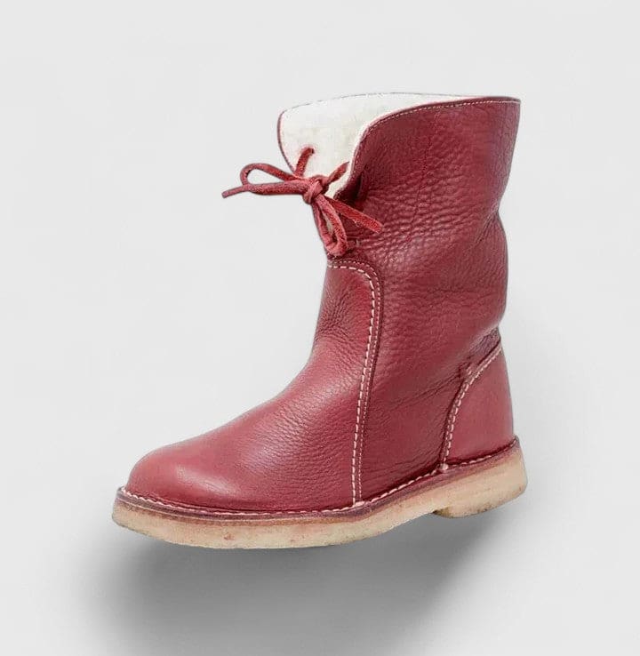 Woman wearing ankle boots with faux fur cuff and lace-up front, styled with jeans._2