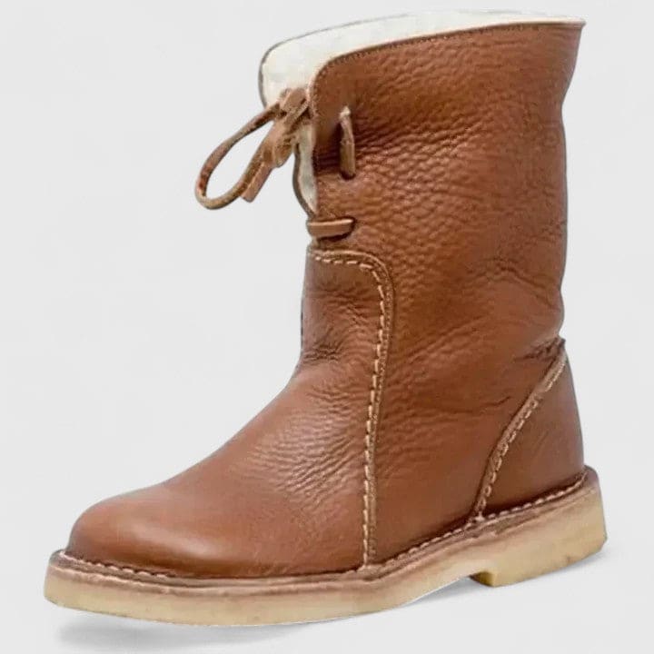 Woman wearing ankle boots with faux fur cuff and lace-up front, styled with jeans._8
