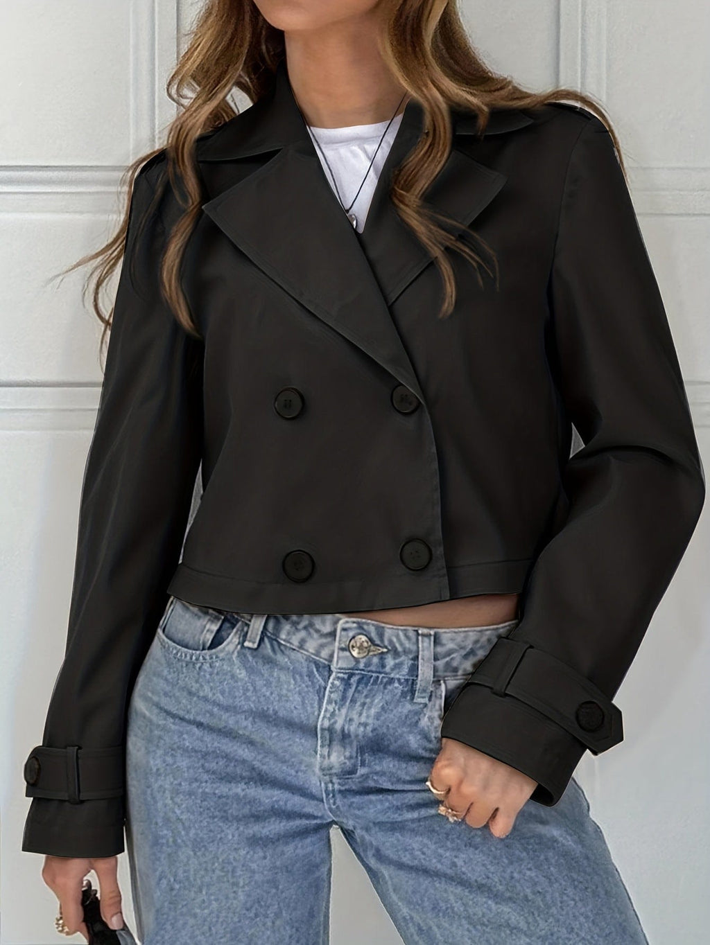 Woman wearing a cropped double breasted pea coat with notched lapel over a white top and light blue jeans._1