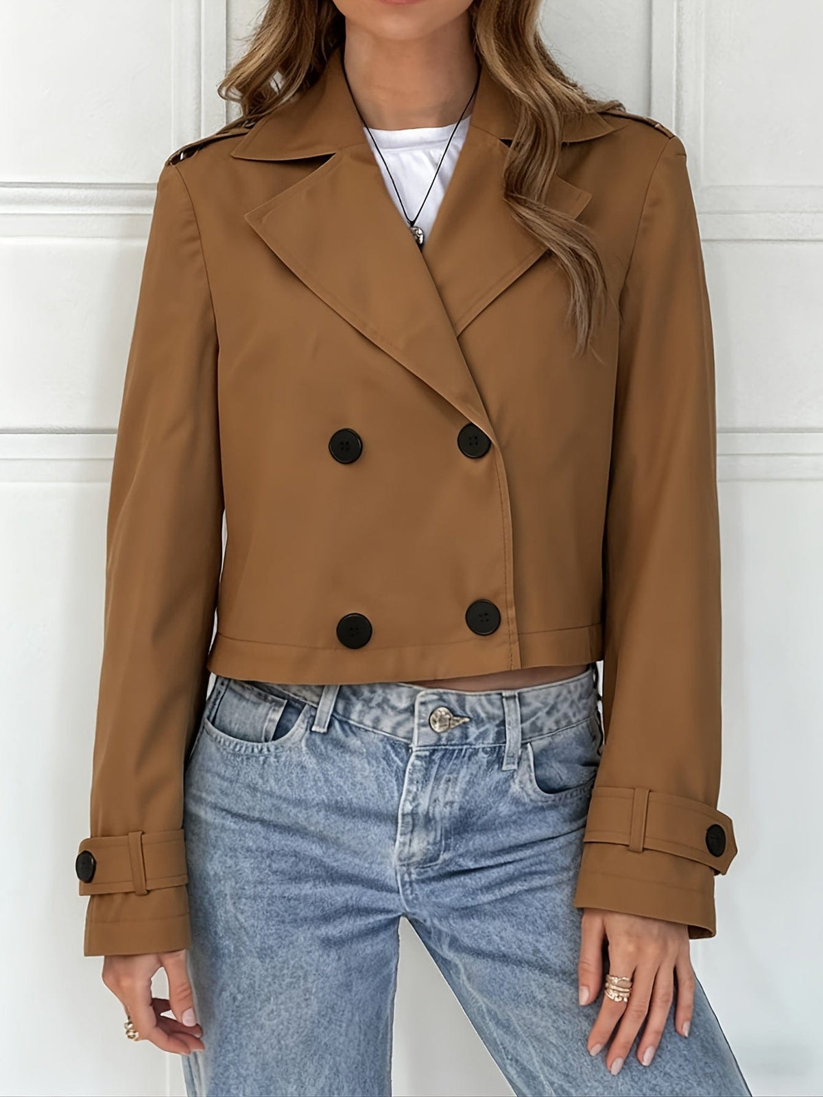 Woman wearing a cropped double breasted pea coat with notched lapel over a white top and light blue jeans._4