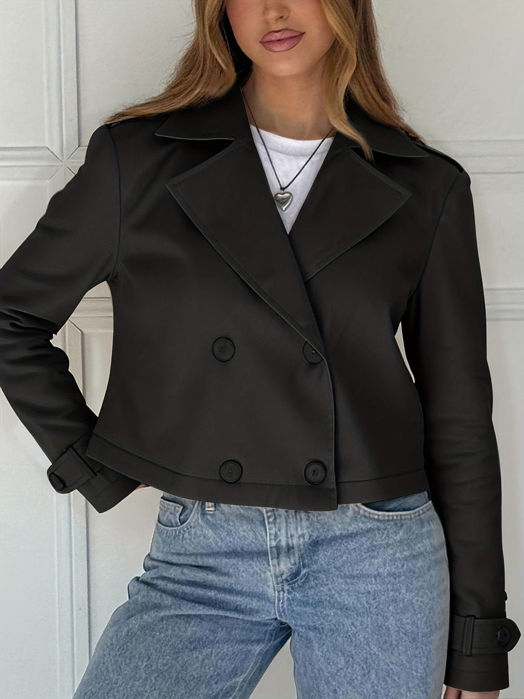 Woman wearing a cropped double breasted pea coat with notched lapel over a white top and light blue jeans._5